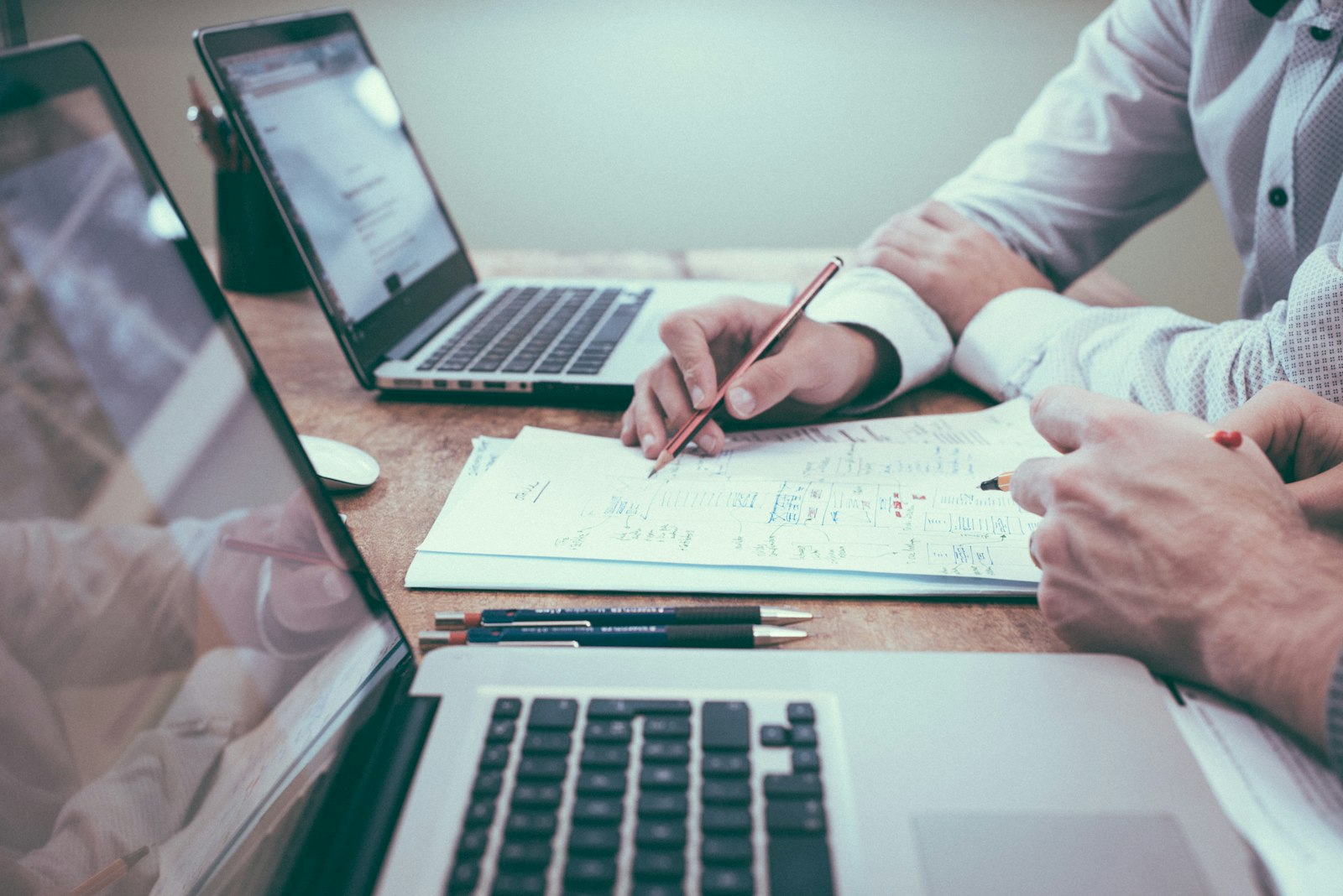 Ingénieurs analysant des plans techniques autour d'une table
